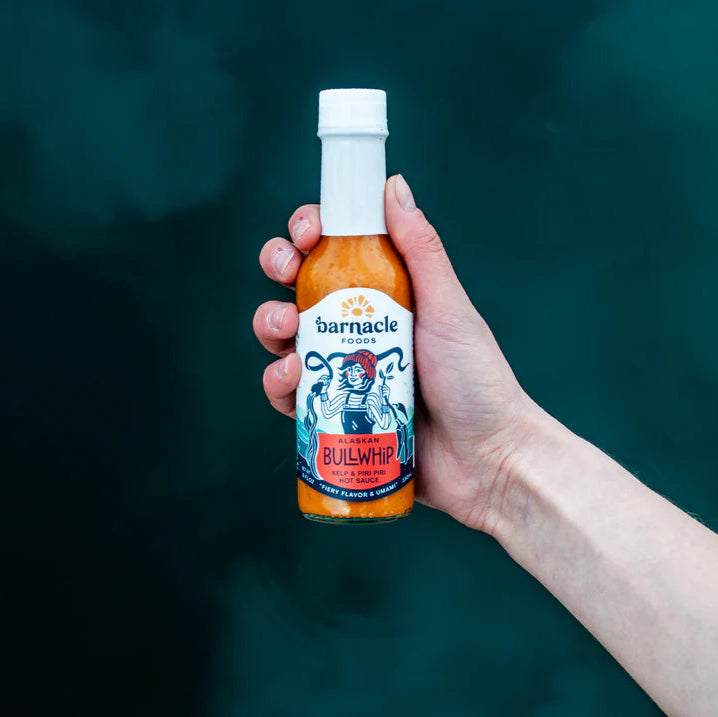Hand holding bottle of Bullwhip hot sauce