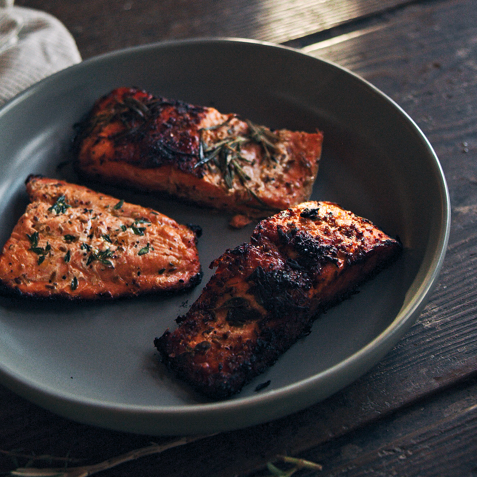Salmon filets cooking in pan
