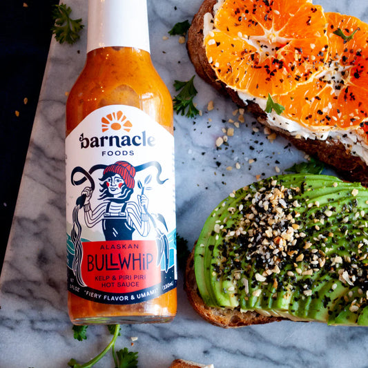 Bottle of Bullwhip hot sauce next to food