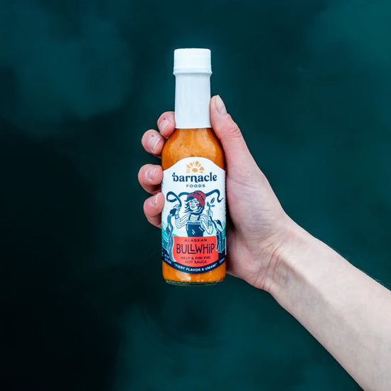 Hand holding bottle of Bullwhip hot sauce