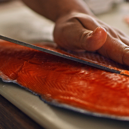 Person cutting raw salmon