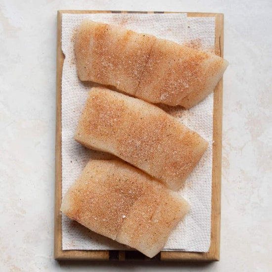 3 raw filets of halibut